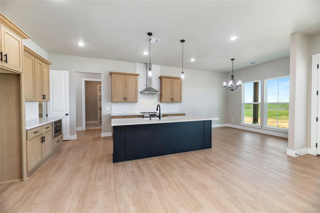 217 Fm 2258 Venus, TX 76084 - Photo 20 of 36 a large kitchen with stainless steel appliances kitchen island granite countertop a large counter top and wooden floors