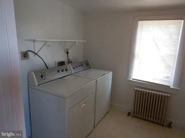 a view of a hallway with wooden floor and a fireplace