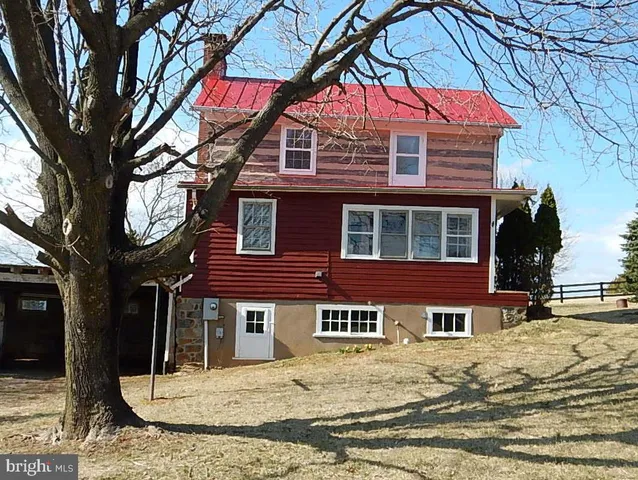 a house that has a tree in front of it