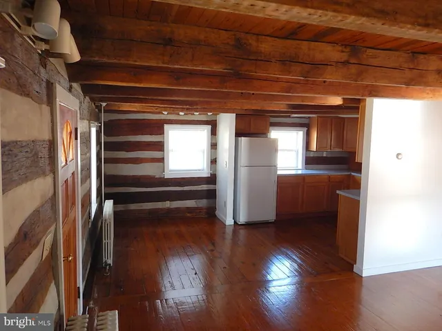 a kitchen with stove and wooden floor