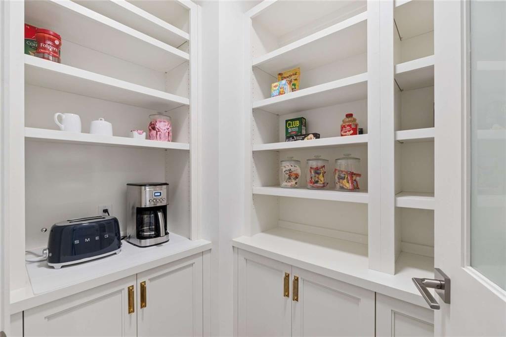 2520 Peachtree Road, Unit 603 Atlanta, GA 30305 - Photo 21 of 91 a kitchen with white cabinets and wooden floor
