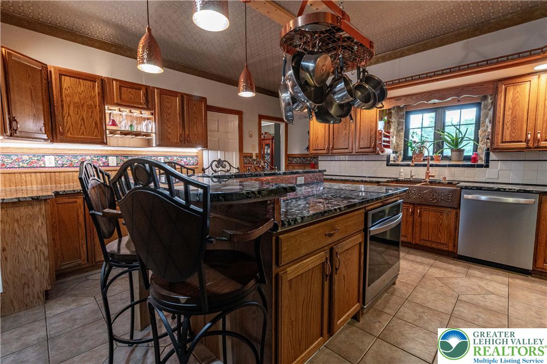 2485 Hieter Road Quakertown, PA 18951 - Photo 14 of 97 A well-appointed kitchen showcasing an island with bar seating and granite countertops.