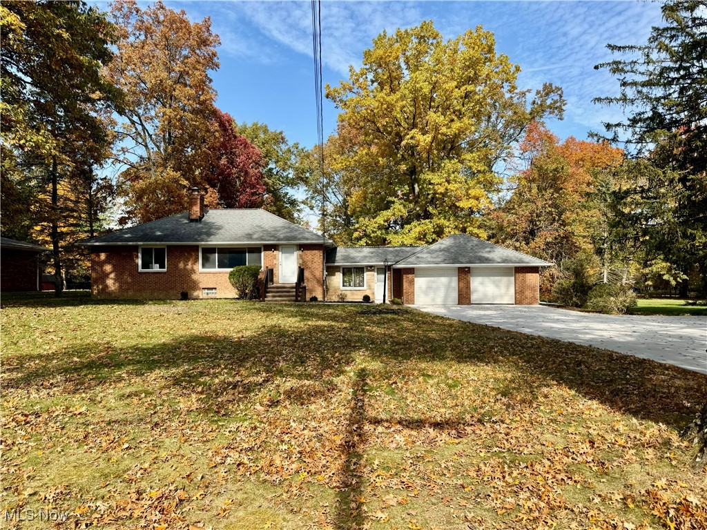 1729 East Pleasant Valley Road Independence, OH 44131 - Photo 1 of 41 Ranch-style house with a front lawn and a garage