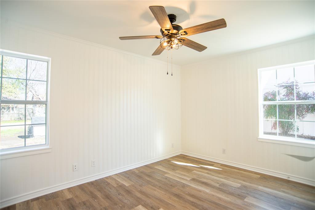 1805 Belden Street Sherman, TX 75092 - Photo 11 of 16 an empty room with a window and a fan