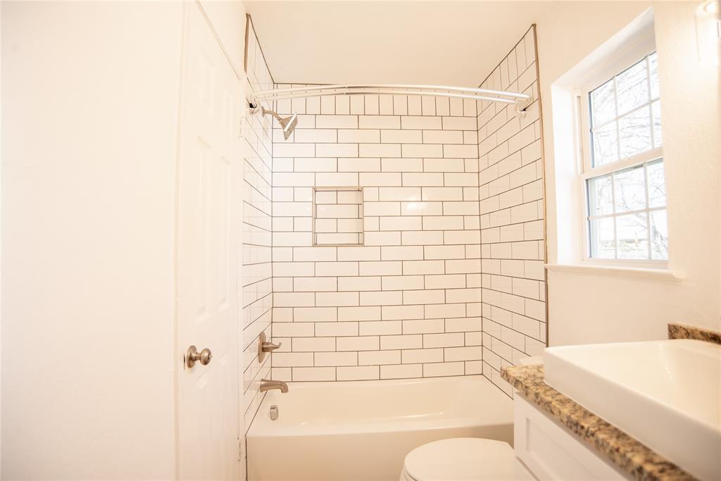 1805 Belden Street Sherman, TX 75092 - Photo 12 of 16 a bathroom with a bathtub and shower