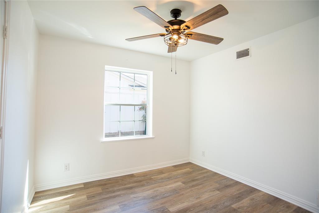 1805 Belden Street Sherman, TX 75092 - Photo 14 of 16 an empty room with a window and a ceiling fan