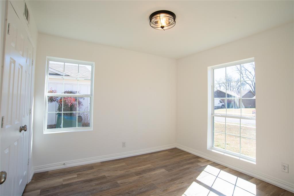 1805 Belden Street Sherman, TX 75092 - Photo 15 of 16 an empty room with wooden floor and windows