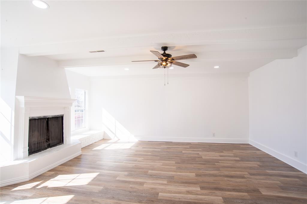 1805 Belden Street Sherman, TX 75092 - Photo 5 of 16 a view of a room with wooden floor and a fireplace