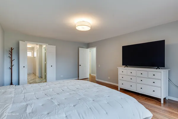 a bedroom with furniture and flat screen tv