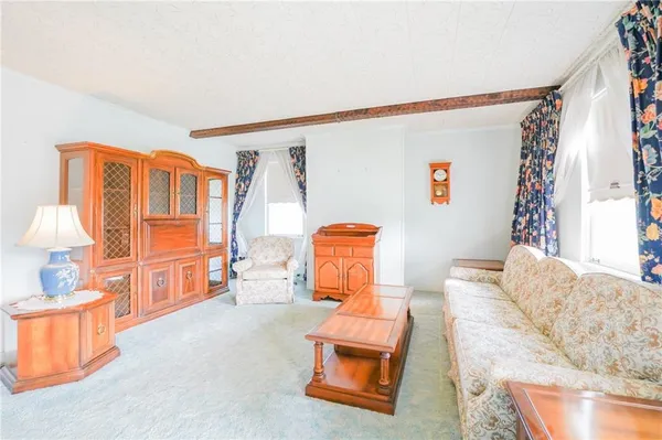 a bedroom with furniture and a large window
