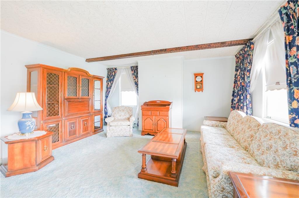 6304 Tuscarawas Road Midland, PA 15059 - Photo 18 of 49 a living room with furniture a flat screen tv and a window
