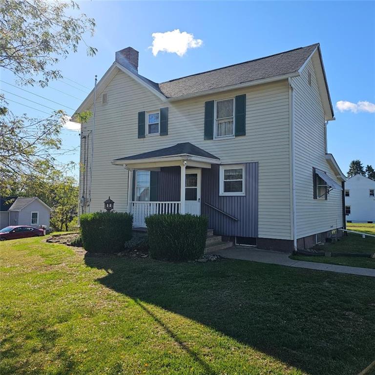 6304 Tuscarawas Road Midland, PA 15059 - Photo 2 of 49 a front view of a house with a garden