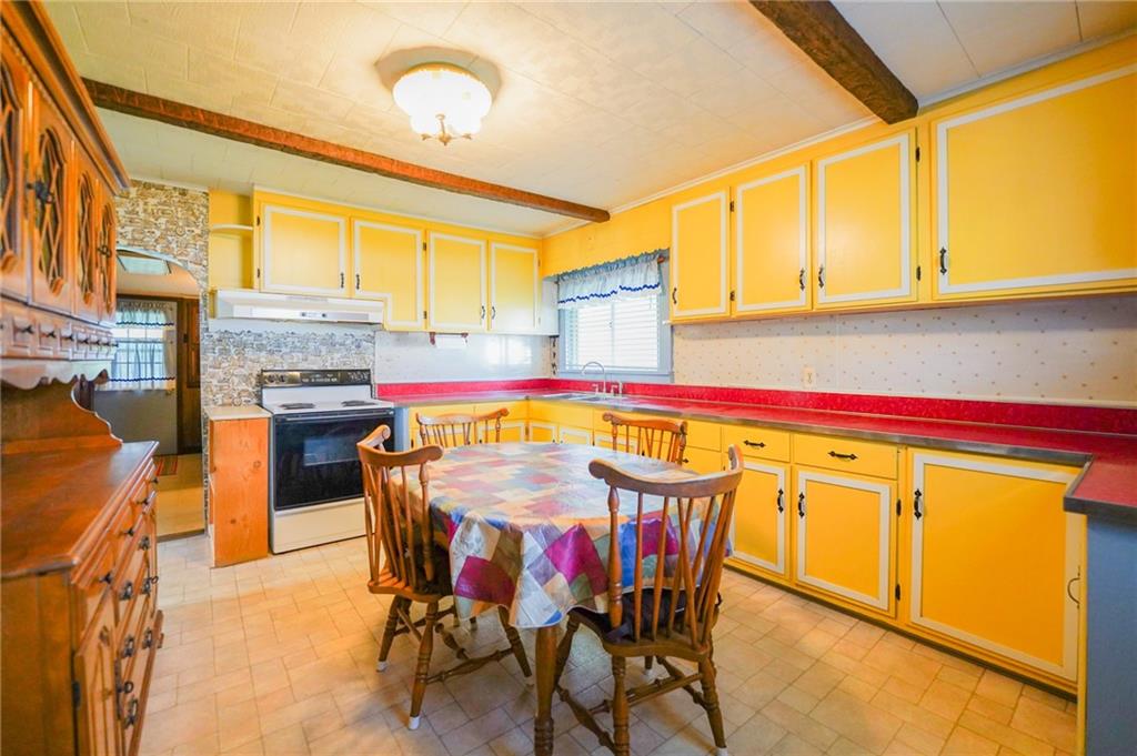 6304 Tuscarawas Road Midland, PA 15059 - Photo 23 of 49 a dining table sitting next to a window