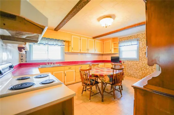 a bedroom with a bed and a refrigerator