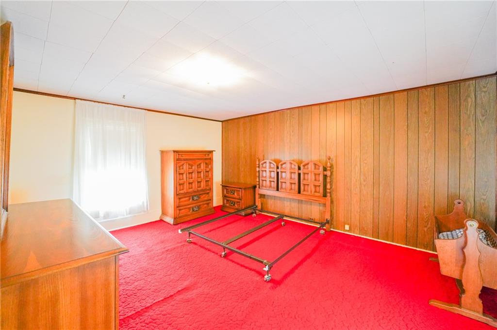 6304 Tuscarawas Road Midland, PA 15059 - Photo 28 of 49 a bedroom with a large bed and a large window