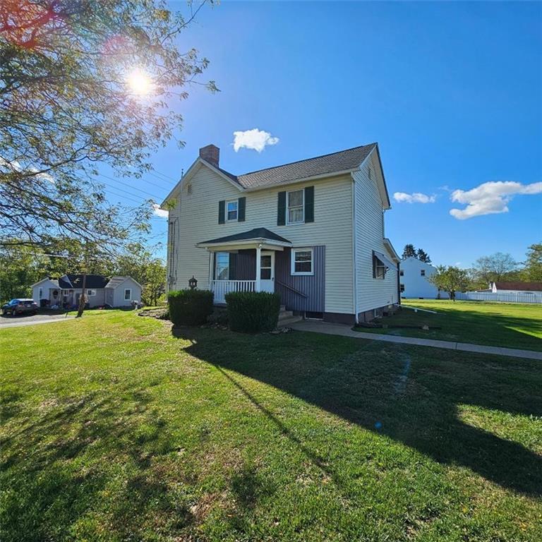 6304 Tuscarawas Road Midland, PA 15059 - Photo 3 of 49 a front view of a house with garden