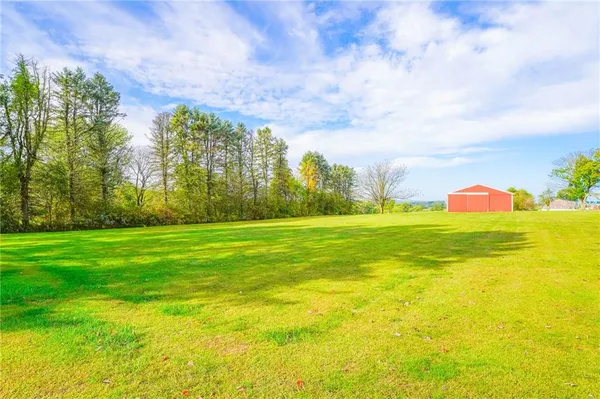 an outdoor view of house with backyard