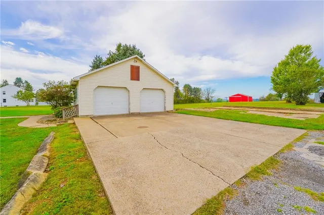 a view of a house with a yard and garage