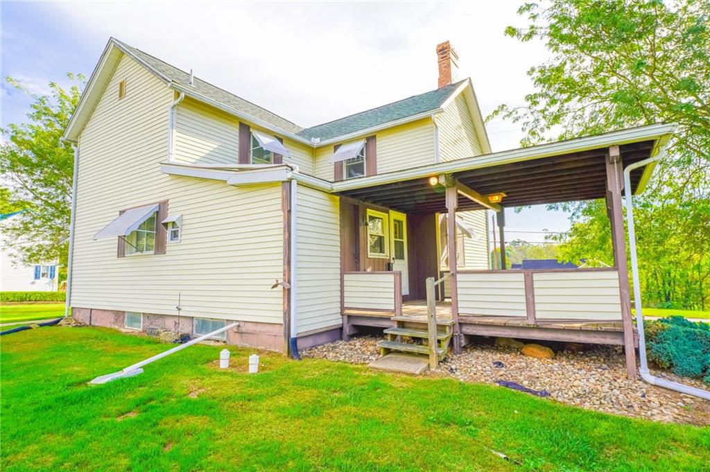 6304 Tuscarawas Road Midland, PA 15059 - Photo 7 of 49 a view of backyard with a garden and deck