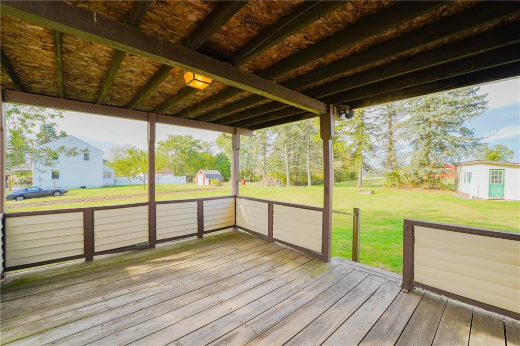 6304 Tuscarawas Road Midland, PA 15059 - Photo 8 of 49 a view of an empty room with wooden floor and iron stairs