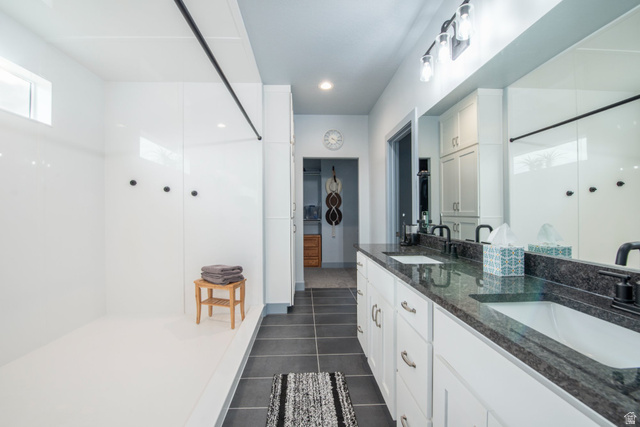 262 North Santa Fe Drive Mapleton, UT 84664 - Photo 17 of 28 Bathroom featuring double vanity, a walk in shower, and dark tile patterned floors