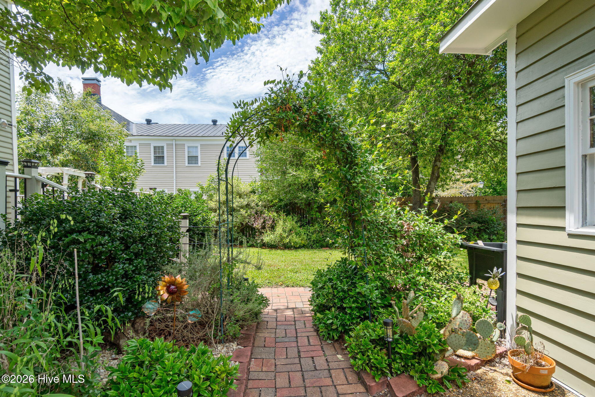 804 Pollock Street New Bern, NC 28562 - Photo 9 of 13 Mature gardens with beautiful brick paver walkways.