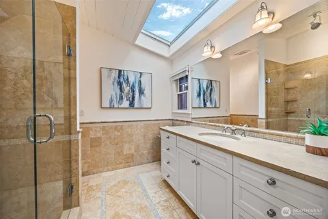 a spacious bathroom with a granite countertop sink mirror and double