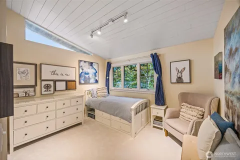 a bedroom with furniture and a large window