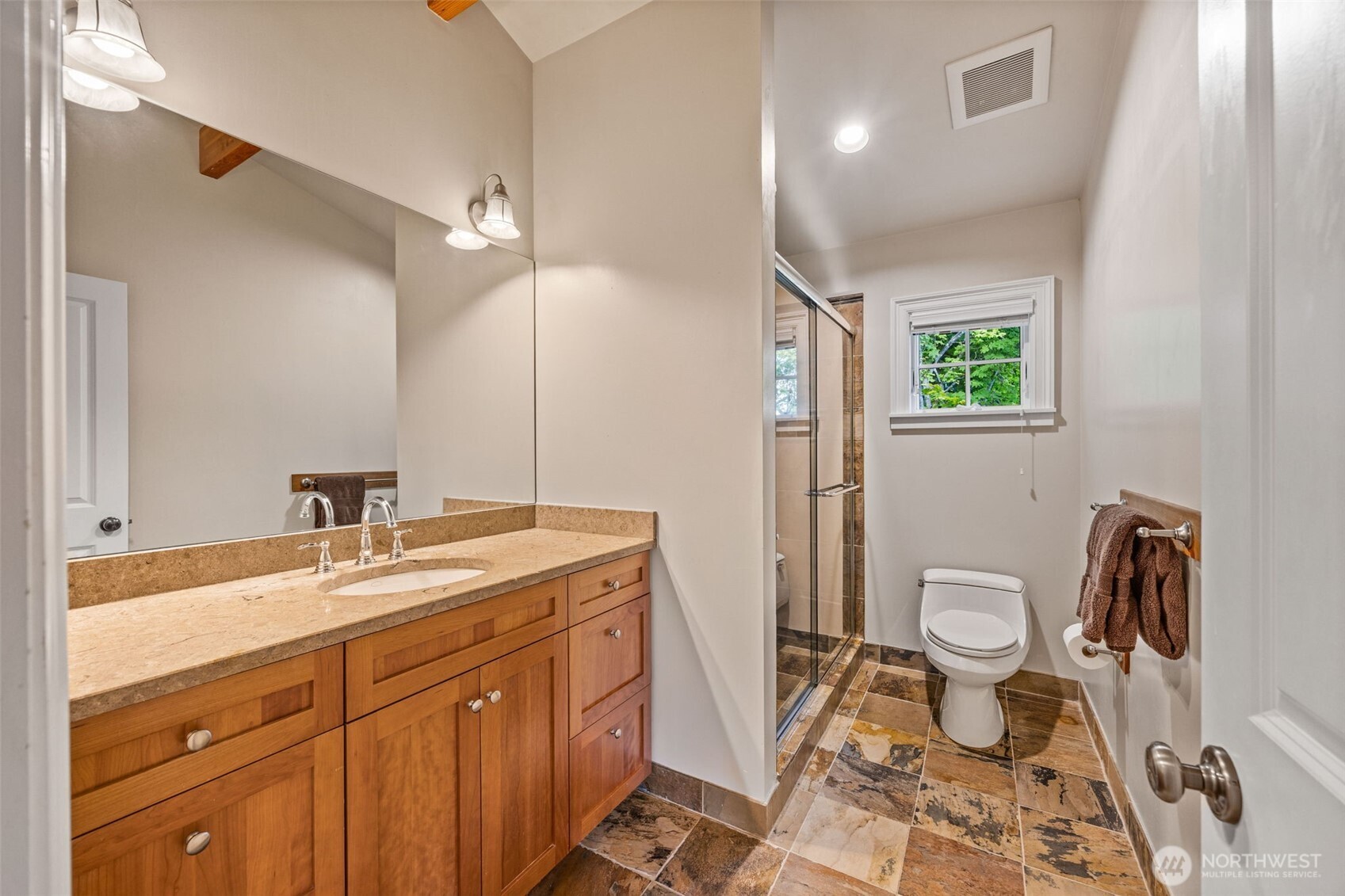8246 East Mercer Way Mercer Island, WA 98040 - Photo 25 of 39 a spacious bathroom with a granite countertop sink a toilet a mirror and vanity