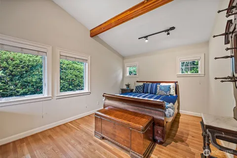 a bedroom with furniture and wooden floor