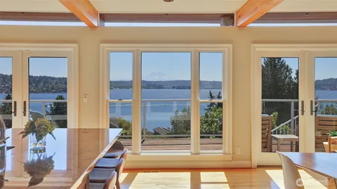 a living room with a large window and furniture
