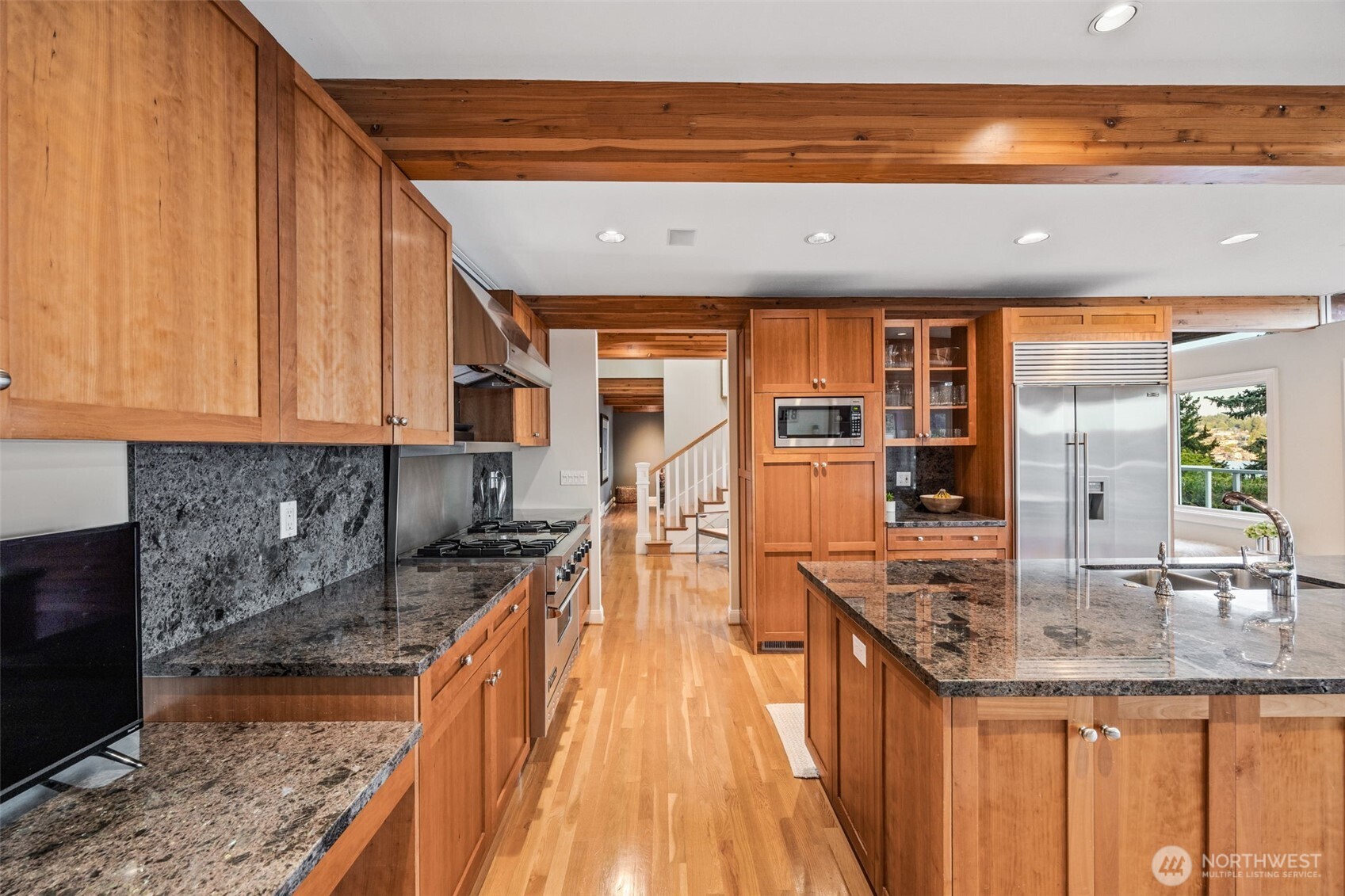 8246 East Mercer Way Mercer Island, WA 98040 - Photo 9 of 39 a kitchen with stainless steel appliances granite countertop a sink and cabinets