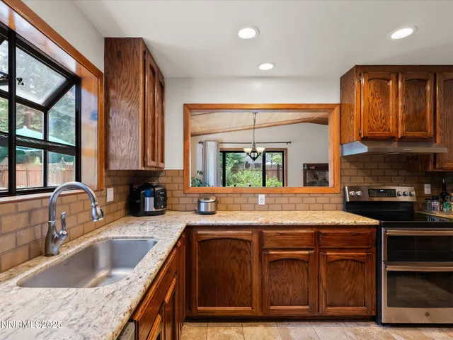 a kitchen with granite countertop sink and cabinets