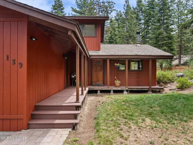 deck with table and chairs under an umbrella
