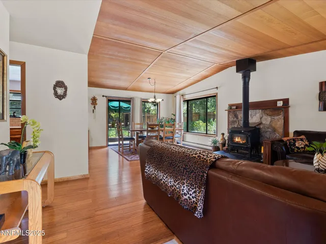 a view of a patio with table and chairs with wooden floor and fence