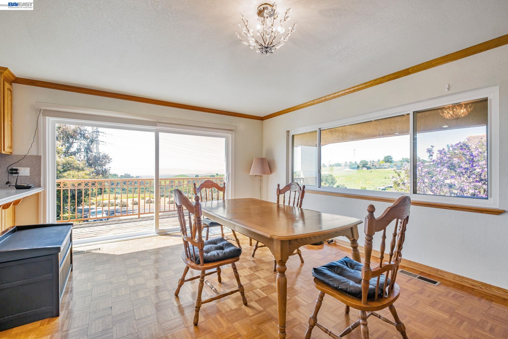 41794 Vargas Road Fremont, CA 94539 - Photo 28 of 60 a dining room with furniture a chandelier and wooden floor