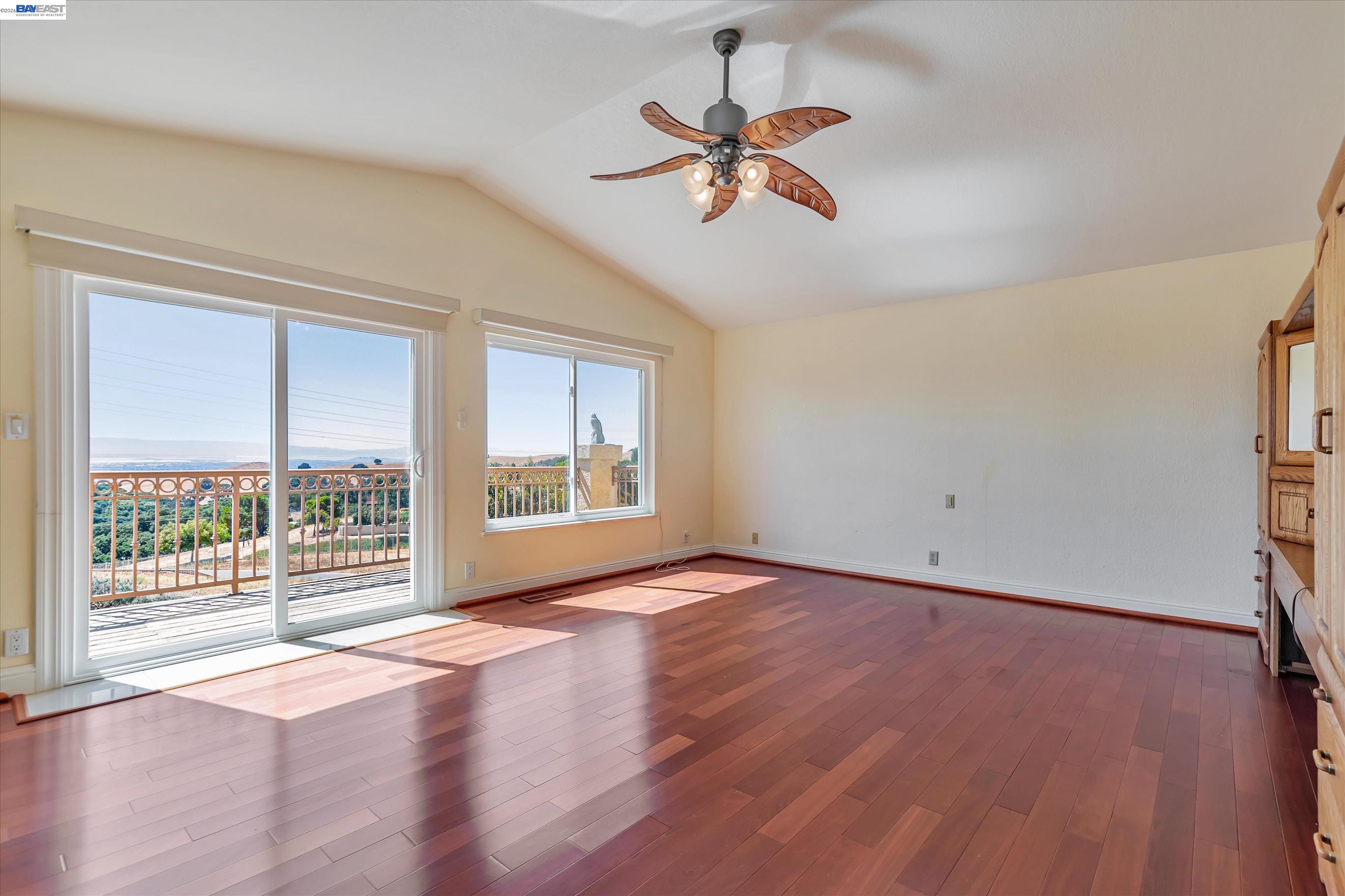 41794 Vargas Road Fremont, CA 94539 - Photo 31 of 60 an empty room with wooden floor fan and windows