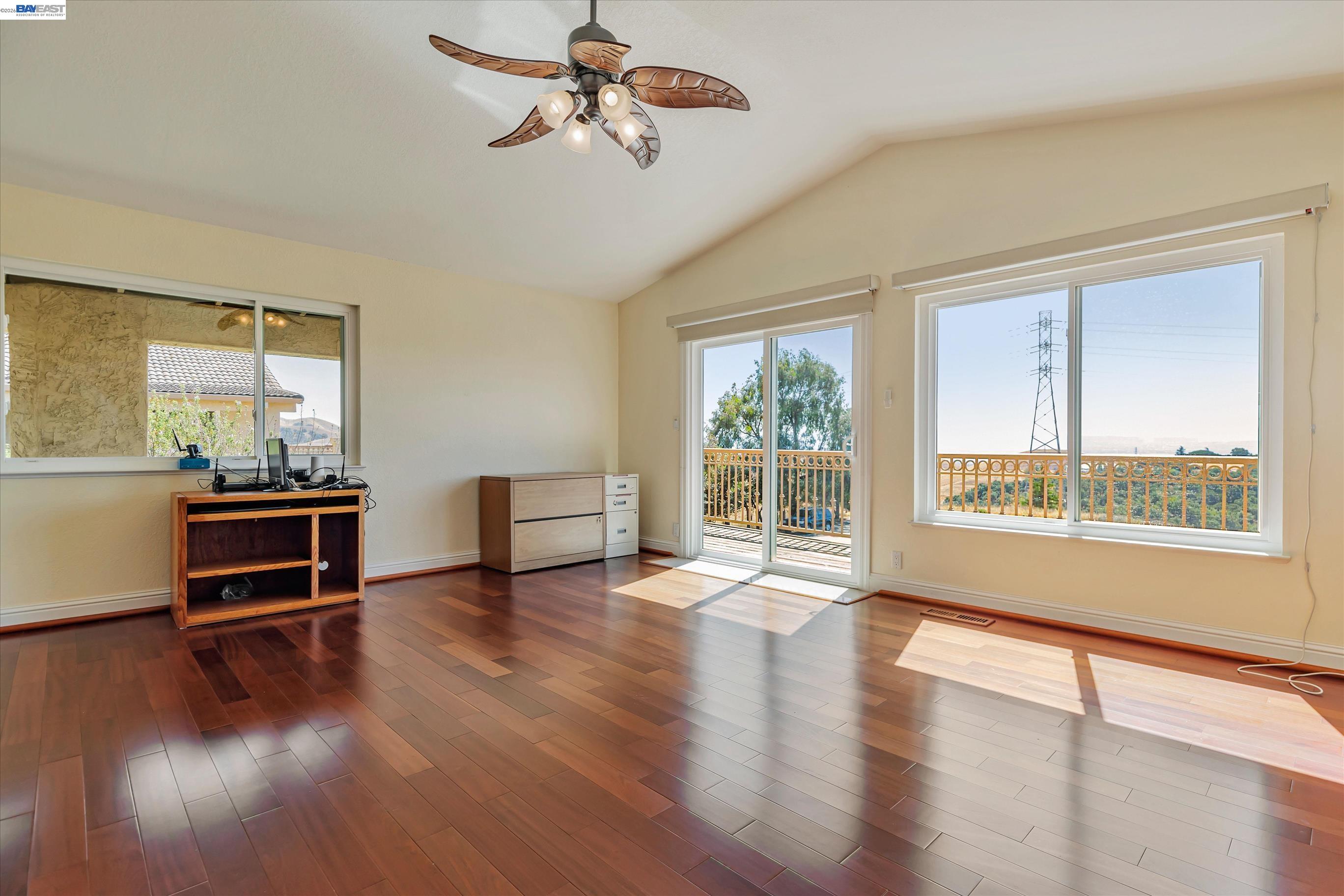 41794 Vargas Road Fremont, CA 94539 - Photo 35 of 60 a view of a livingroom with furniture hardwood floor a ceiling fan and windows