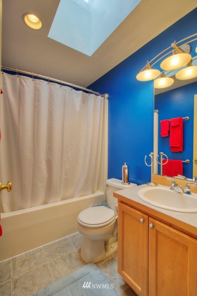 6733 Northeast 1st Place Renton, WA 98059 - Photo 22 of 25 a bathroom with a sink a toilet and shower