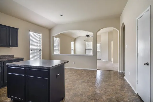 a kitchen with stainless steel appliances granite countertop a refrigerator and a stove