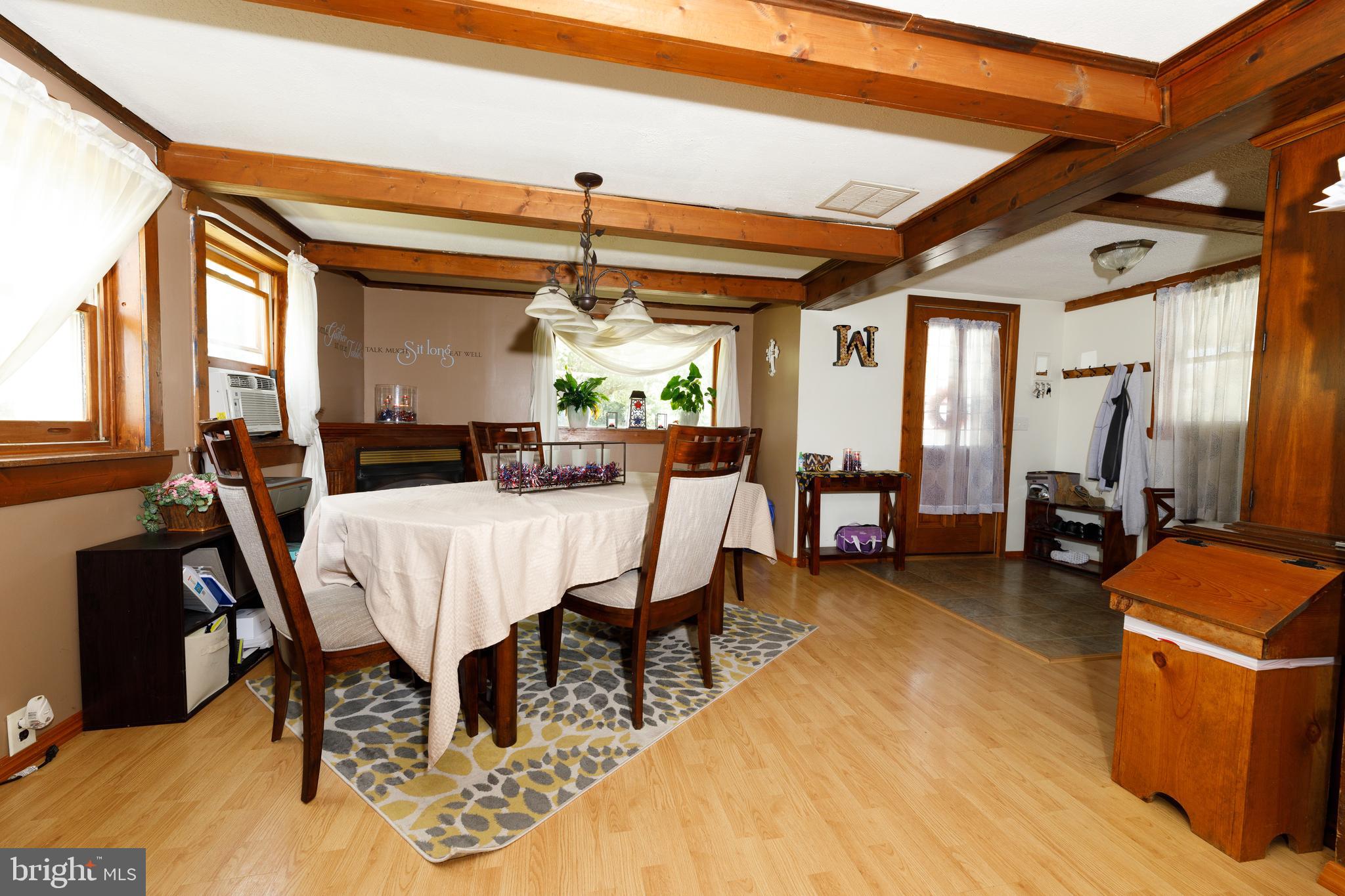 706 Camp Road Denton, MD 21629 - Photo 6 of 20 a view of a dining room with furniture a chandelier and wooden floor