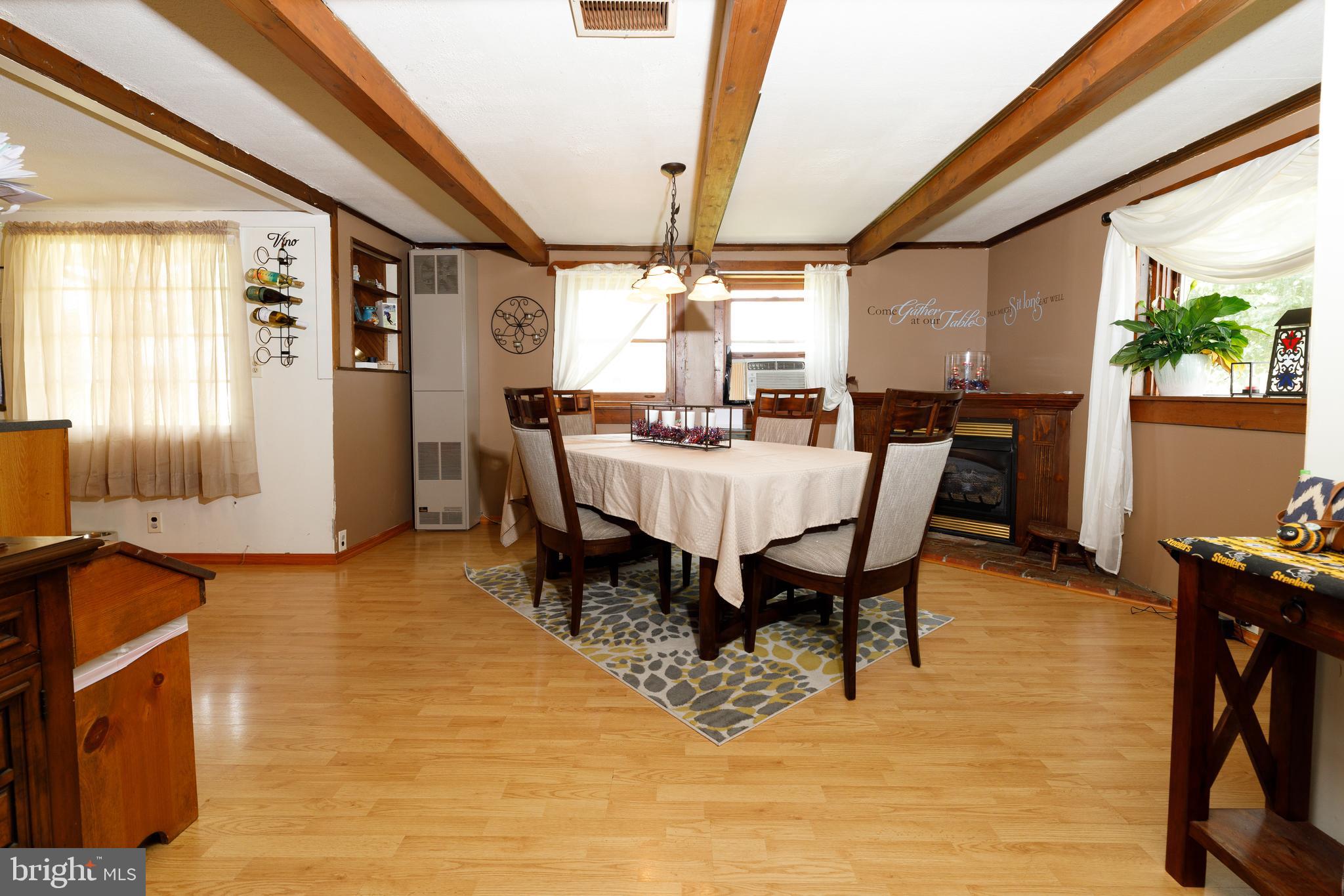 706 Camp Road Denton, MD 21629 - Photo 7 of 20 a view of a dining room with furniture window and wooden floor