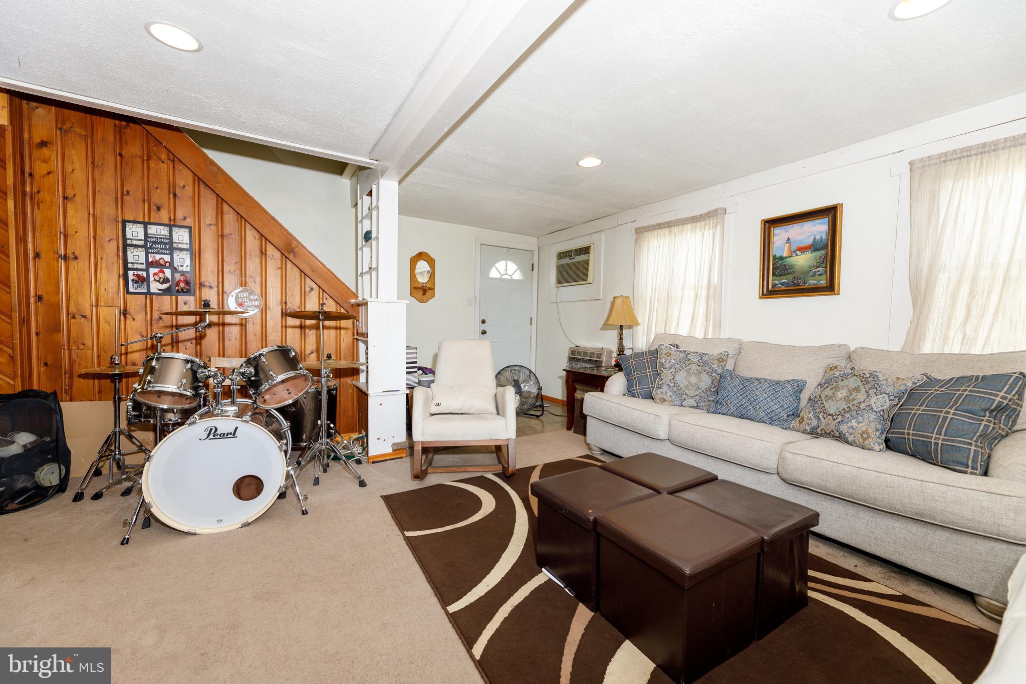 706 Camp Road Denton, MD 21629 - Photo 8 of 20 a living room with furniture a rug and a large window