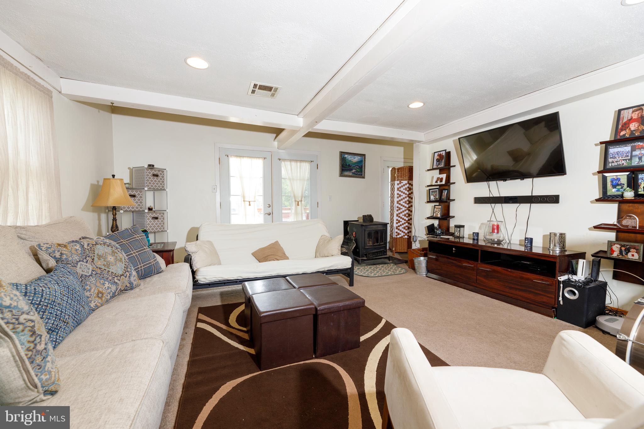 706 Camp Road Denton, MD 21629 - Photo 9 of 20 a living room with furniture and a flat screen tv