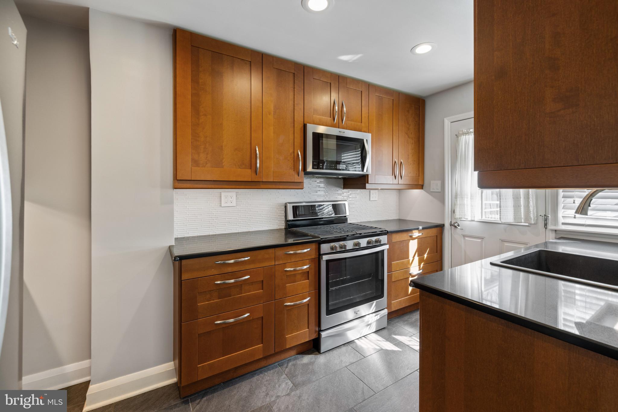 1876 Edgewood Road Towson, MD 21286 - Photo 11 of 32 a kitchen with stainless steel appliances granite countertop a stove a sink and a microwave