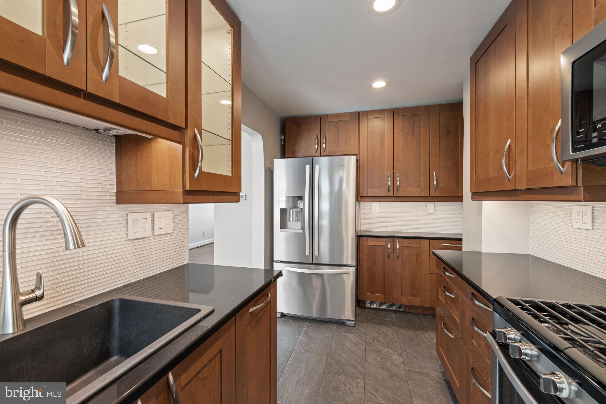 1876 Edgewood Road Towson, MD 21286 - Photo 13 of 32 a kitchen with a refrigerator and a sink