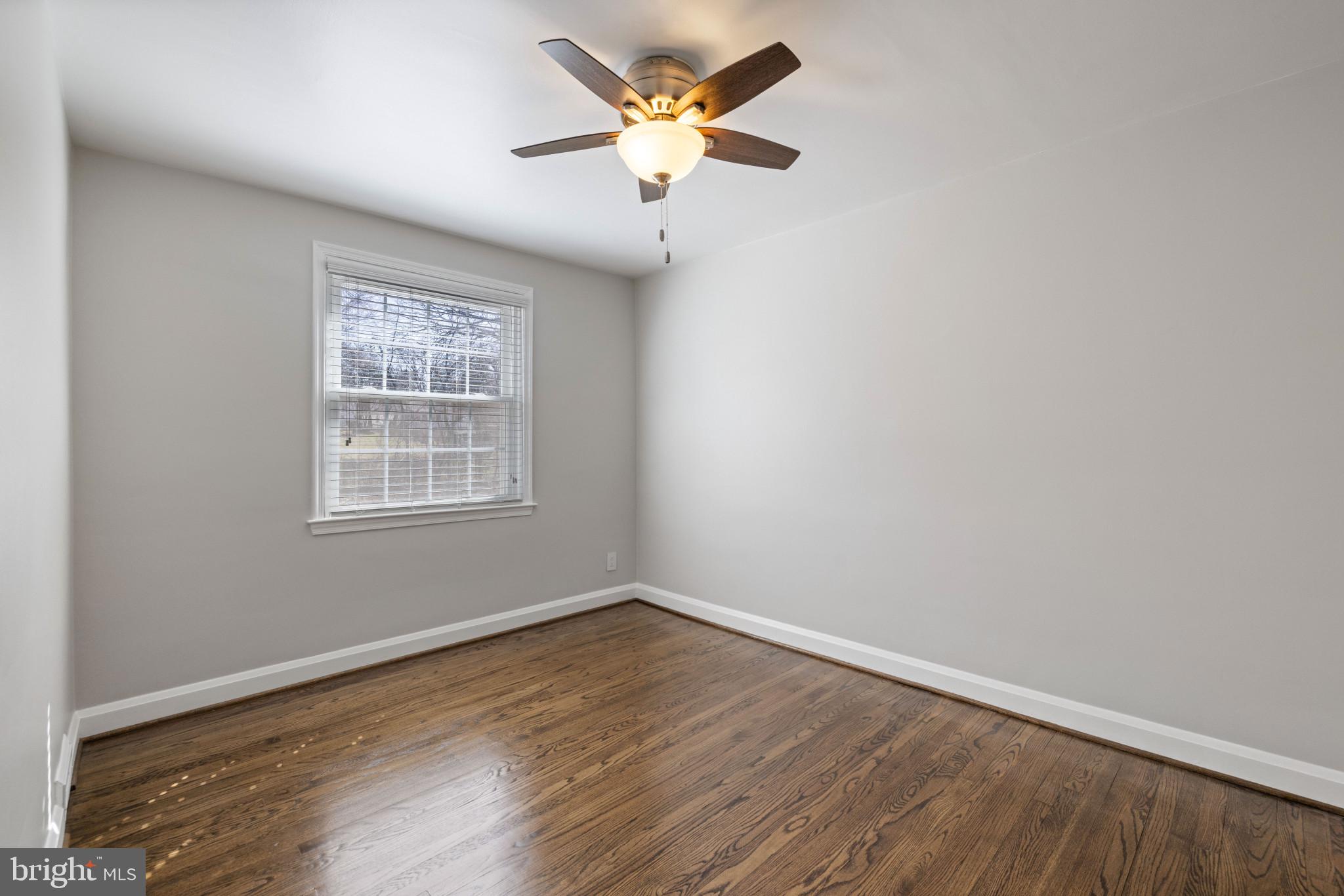 1876 Edgewood Road Towson, MD 21286 - Photo 16 of 32 wooden floor in an empty room with a window