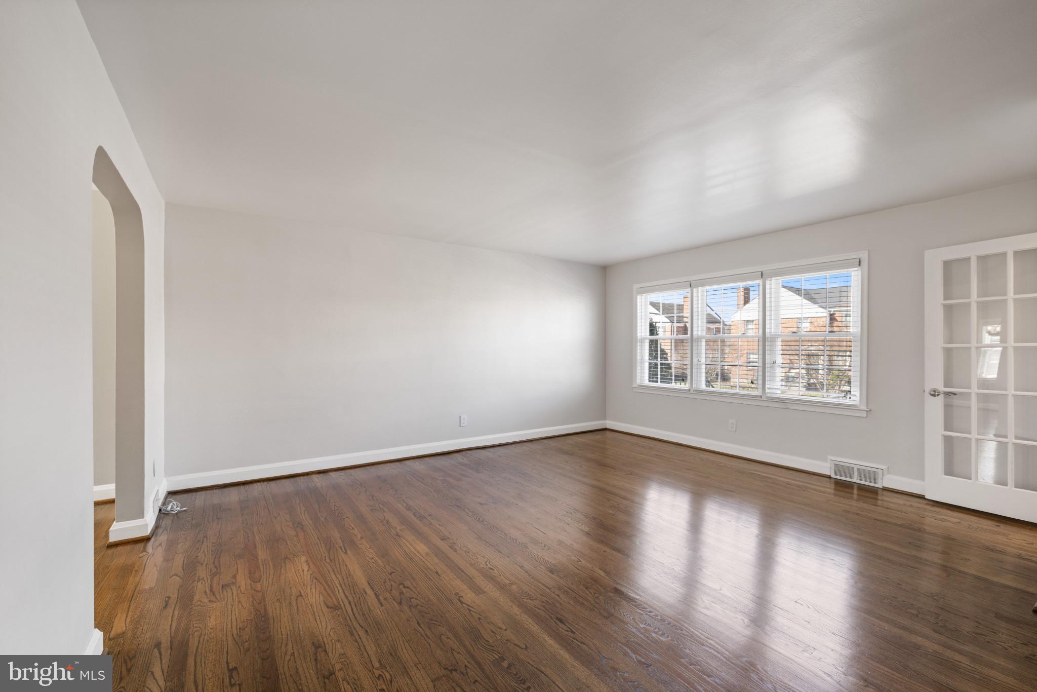 1876 Edgewood Road Towson, MD 21286 - Photo 7 of 32 an empty room with wooden floor and windows