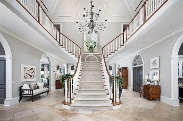 a living room with furniture and floor to ceiling windows