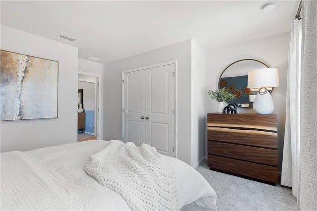 a bedroom with a bed and a dresser